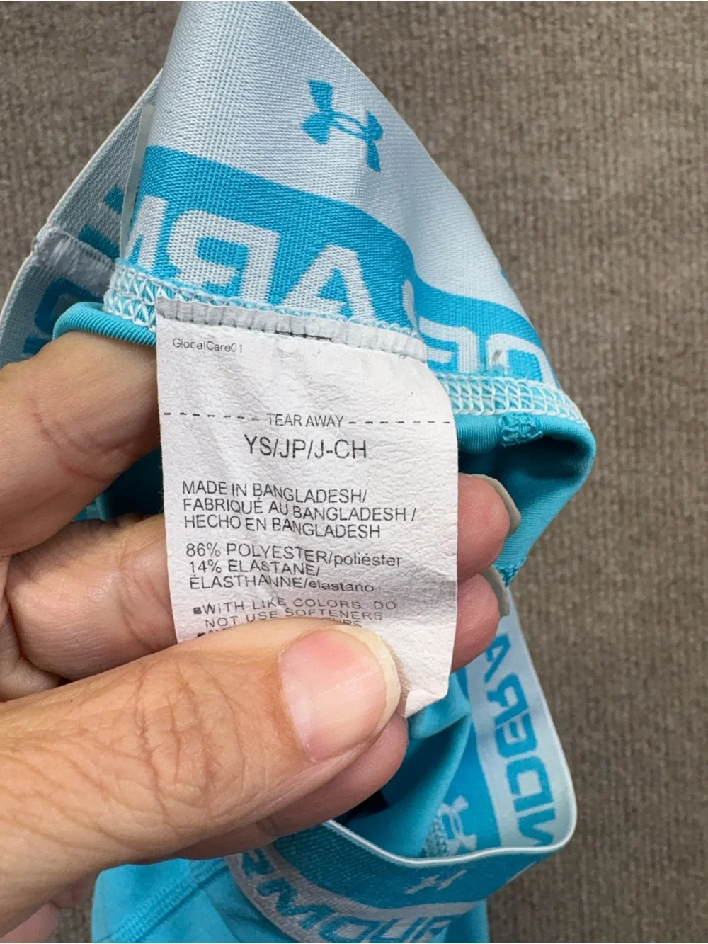 Under Armour YS are a teal blue with a logo elastic waistband